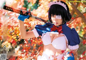 A woman dressed in a maid outfit holding a pair of handcuffs.
