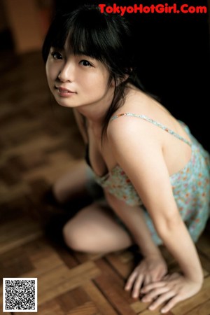 A woman in a bikini laying on the floor.