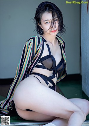 A woman laying on top of a bed in lingerie.