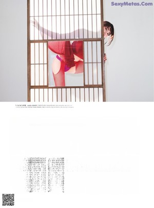 A woman in a red lingerie is looking out of a window.