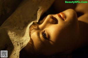 A woman in a white lingerie leaning against a window.