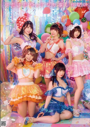 A group of girls standing in front of a bunch of balloons.