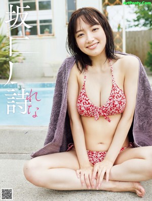 A woman in a blue bikini laying on a bed.