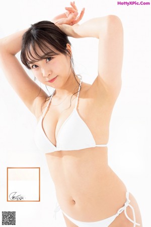 A woman in a blue bikini posing for a picture.