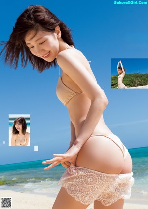 A woman in a brown bikini sitting on a beach.