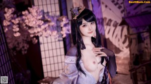 A woman in a kimono is posing for a picture.