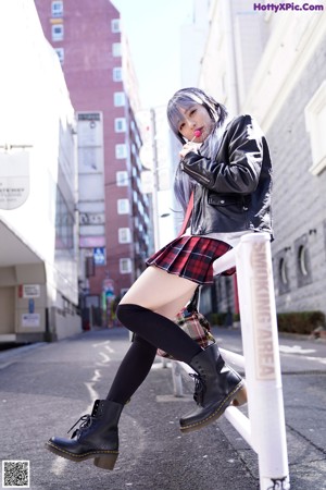 A woman sitting on the steps of a building.