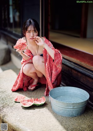 A woman in a red dress posing for a picture.