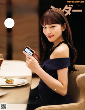 A woman taking a picture of herself with a cell phone.