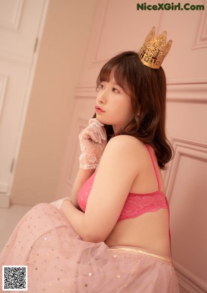 A naked asian woman holding a book in her hand.
